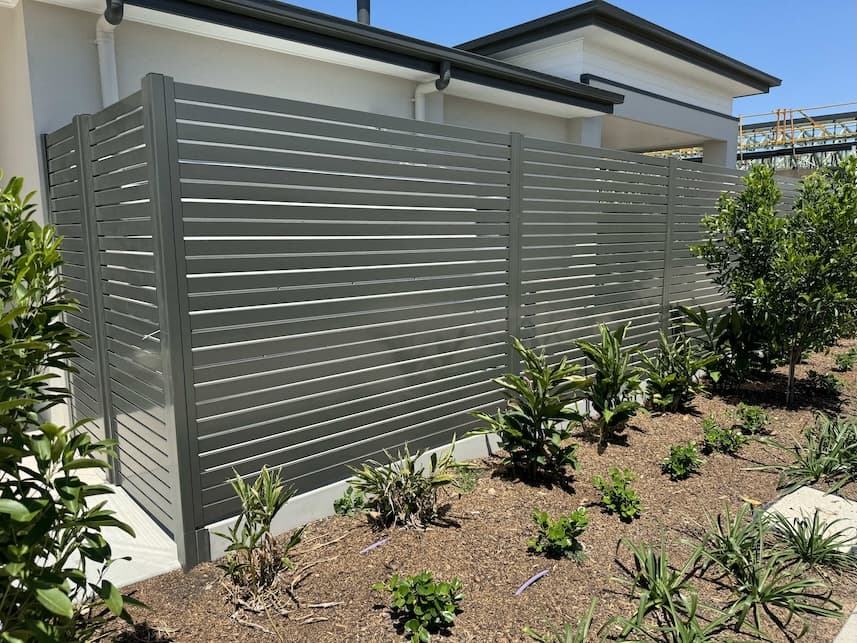 Grey aluminium slat fence installed at a contemporary Australian home showing horizontal design and modern aesthetic