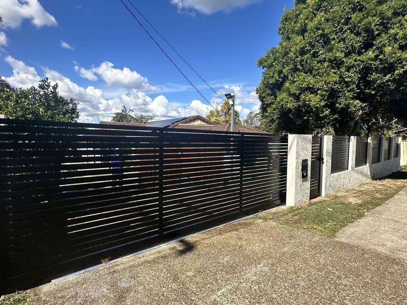 Powder-coated black aluminium driveway gate and fence in Brisbane