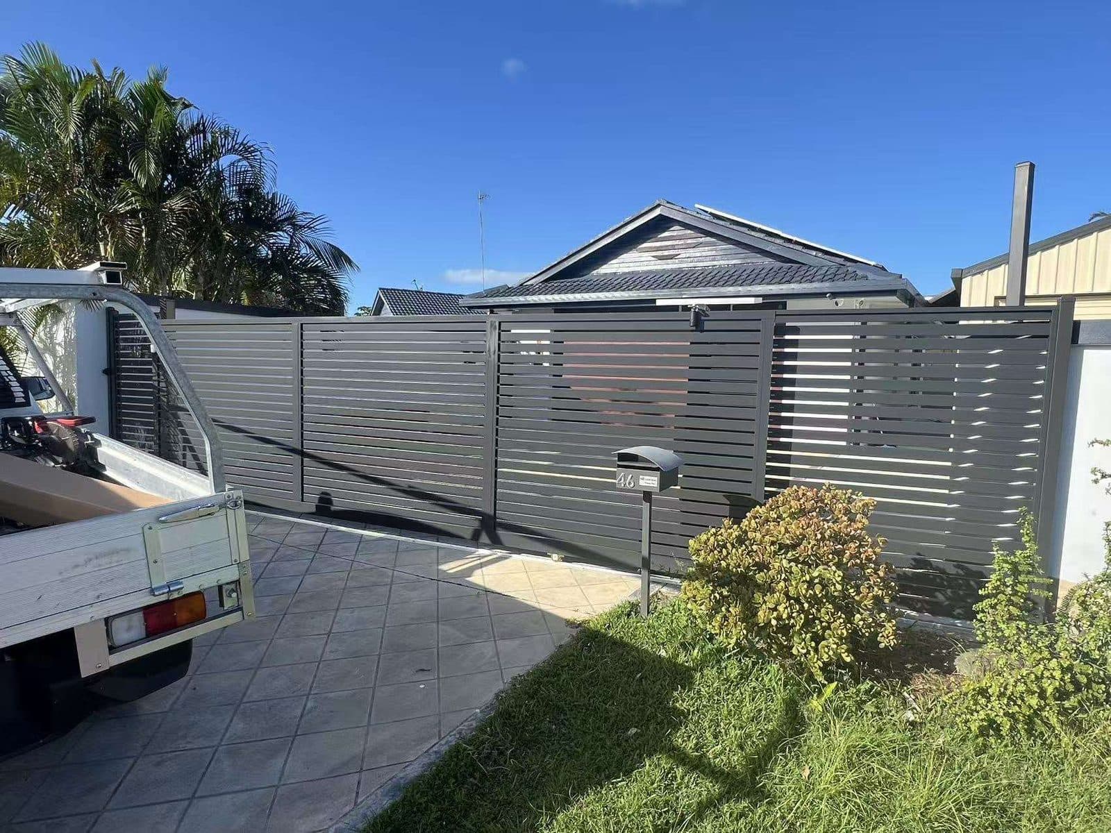Aluminium slat gate and matching fence in a Brisbane yard