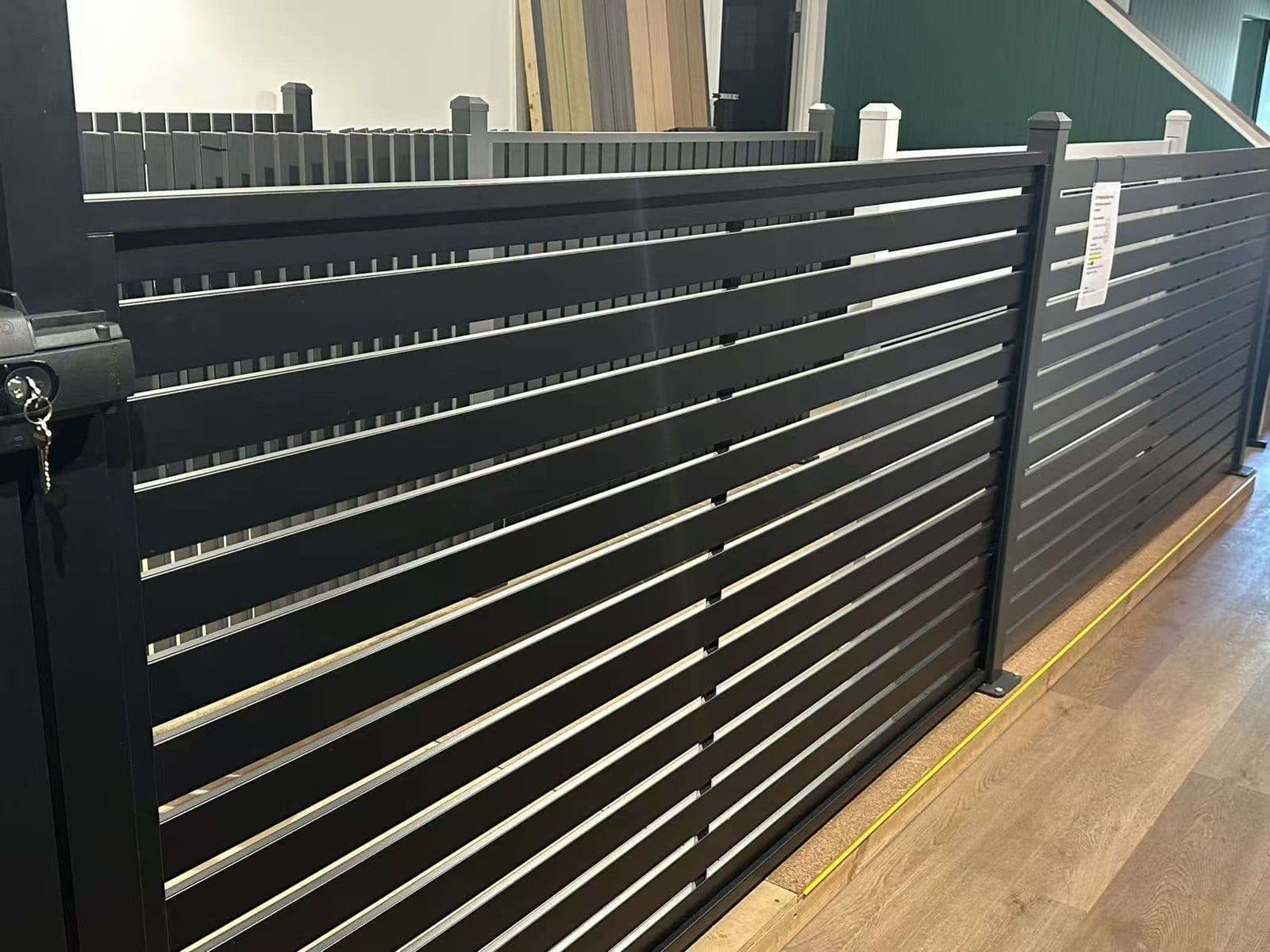 Black aluminium horizontal slat fence panel and gate on display in the FY Fencing Brisbane showroom